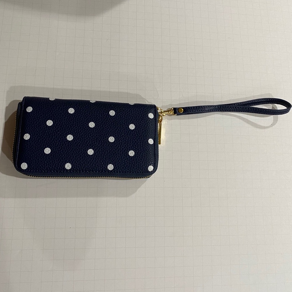 Blue and white polka dot wallet with a strap